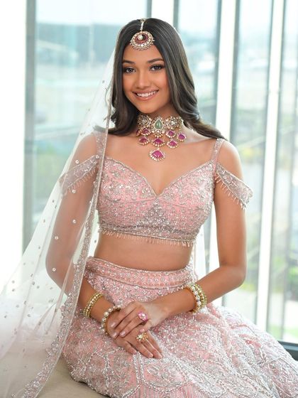 Radiating pure happiness. The makeup is designed to enhance her joyful expression, with a focus on bright eyes and a natural, luminous complexion.