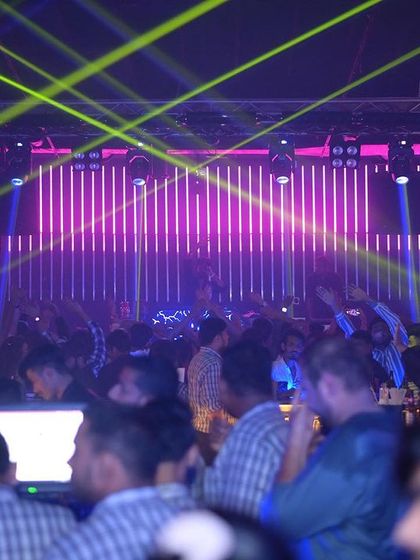 The view from the side of the club, showing the impressive laser setup and a full room of guests.