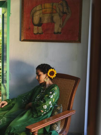 A sunflower in her hair adds a touch of warmth to this peaceful portrait for Baavli. The natural light and relaxed pose create an intimate, in-home feeling that is central to my work.