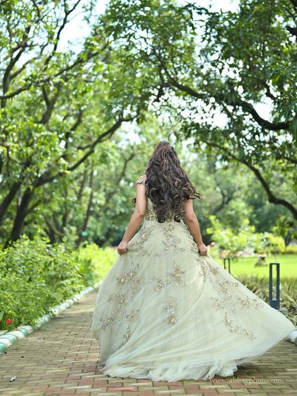 A back view of the pastel green gown, showing how the light and airy tulle skirt flows beautifully with movement.