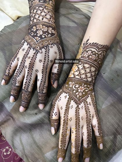 A variation of the hathphool design, with different cuff patterns on each wrist but the same elegant finger details.