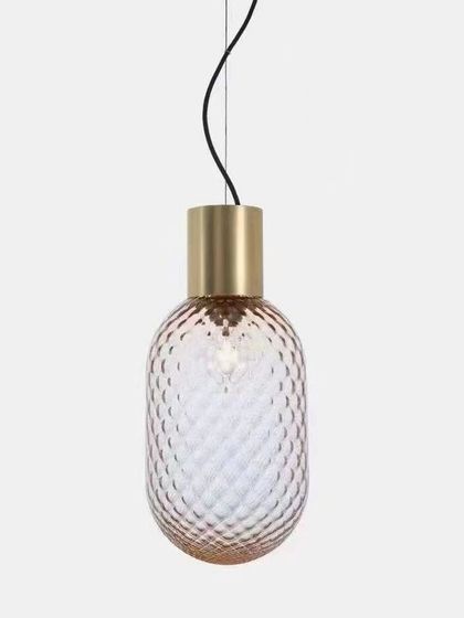 The Bloom LED pendant light features a diamond-patterned glass shade that creates a beautiful, textured glow. This hanging lamp is a simple yet elegant addition to any space, providing a warm and decorative touch.