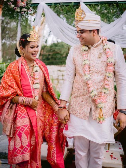 A happy couple holds hands after their wedding ceremony at our Backyard venue. This photo captures the joy of an intimate celebration in a modern, green space.