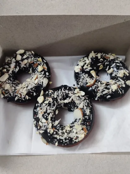For a bit of crunch, I offer these chocolate donuts topped with a generous amount of sliced almonds. The nutty flavor is a great combination with the rich chocolate glaze.