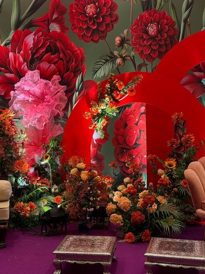 An identical image to 67, showing the vibrant and creative decor for a pre-wedding celebration. The mix of bold colors, patterns, and textures creates a festive and artistic environment.