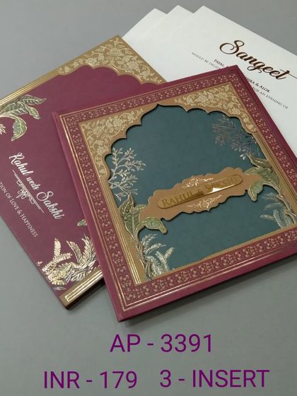 This card combines a rich maroon cover with a teal interior, revealed through a laser-cut arch. The gold foil details add a touch of luxury to this three-insert invitation.