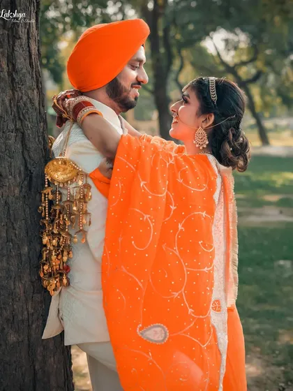 A candid moment of laughter between the couple during their outdoor pre-wedding session. These are the unposed, happy moments that truly reflect a couple's bond.
