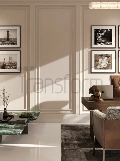 A workspace designed to elevate creativity and style. The room combines a comfortable seating area with a functional desk, framed by classic wall paneling and a gallery of black-and-white photographs for a personal touch.