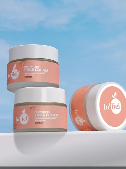 A creative composition of In'lief face cream jars stacked against a sky background. This conceptual shot is great for social media campaigns and branding.