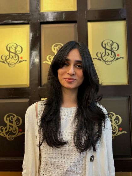 A beautiful smile to go with a beautiful new haircut. The layers and bangs work together to create a flattering shape that is both stylish and easy to wear.