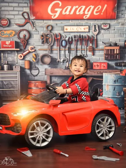 For the little car enthusiast, my garage-themed shoot is always a winner. Complete with a cool ride-on car and a detailed tool-shop backdrop, it's a fun and imaginative session for your toddler.