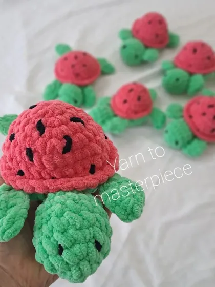 Holding a watermelon turtle to show its details.