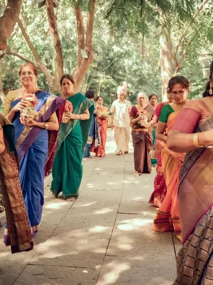 A beautiful procession of women in colorful sarees during a traditional South Indian wedding ceremony. We capture the cultural richness and vibrant details of your special day.