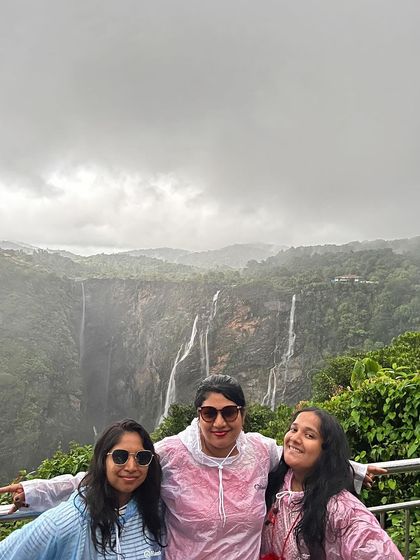 A group posing in front of the magnificent Jog Falls.