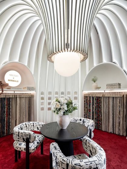 The central meeting space, framed by the soaring, illuminated fabric fins. The design creates a sense of intimacy and grandeur simultaneously, making it the perfect place to appreciate the textures and patterns of the fabrics on display.