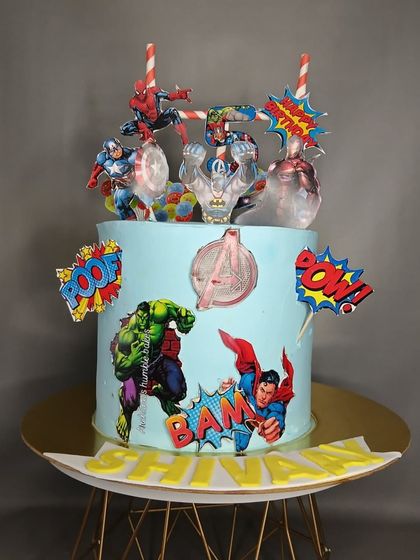 An action-packed Avengers theme cake for a young superhero fan. This cake brings together Iron Man, Captain America, Hulk, and Spider-Man for an epic birthday battle.