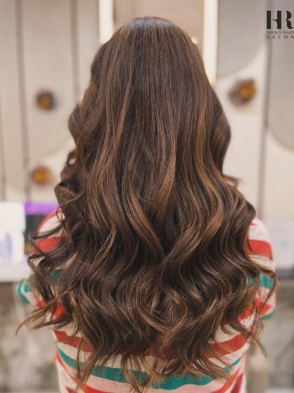 Soft, flowing waves are perfect for any pre-wedding event. This style showcases the beautiful, rich tones of a global hair colour, enhanced with subtle highlights for depth and movement.