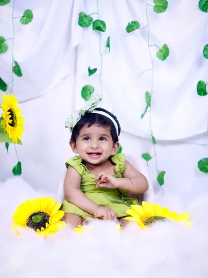 A beautiful, toothy grin from a one-year-old during her sunflower-themed birthday shoot.