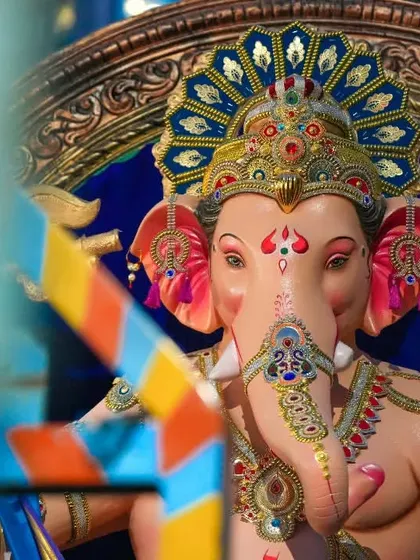A beautifully framed close-up of the Sanpada Cha Raja, using foreground elements to add depth to the portrait.
