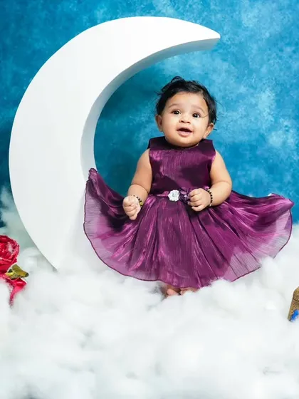 Another beautiful moon theme portrait. The rich blue background and the baby's purple dress create a lovely color contrast in this enchanting setup.