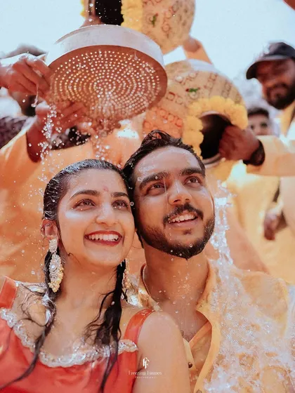The pure, unscripted joy of a Haldi ceremony. I focus on capturing these genuine smiles and laughter as family and friends shower the couple with blessings and turmeric-infused water.
