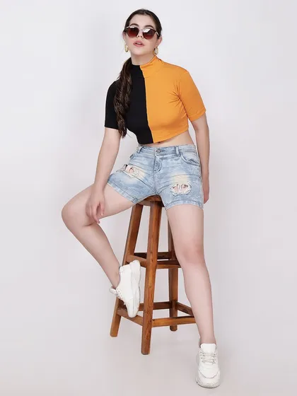 A full-length seated pose on a stool gives a different perspective on the outfit, showing the product in a more relaxed context.