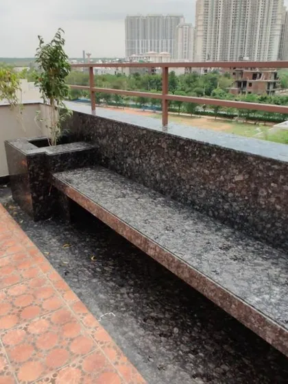 A close-up of the custom-built seating on the terrace. We used the same durable granite as the bar to create a cohesive look and provide permanent, weather-proof seating.