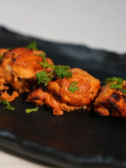 Juicy and succulent, our Murgh Rasila Tikka features chicken pieces marinated in a special blend of spices and yogurt, then grilled to perfection. It's a classic tandoori starter that never disappoints.