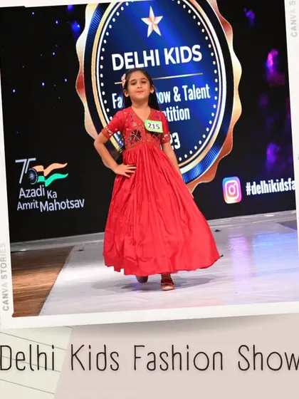 A beautiful red gown with intricate embroidery on the bodice. This participant walks with poise, showcasing a more traditional and elegant side of children's fashion.
