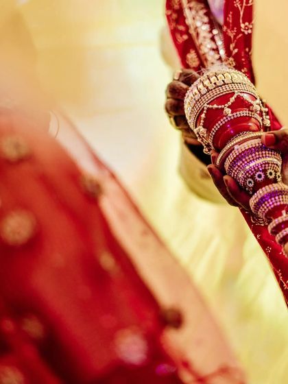 A detail-focused shot of the sindoor daani, the ornate container holding the vermilion. This perspective highlights a key cultural artifact of the Hindu wedding ceremony, showing its beauty and importance.