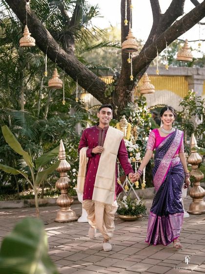 A happy couple walking hand-in-hand through a beautifully decorated outdoor wedding venue. Their smiles show the joy of finally being married.