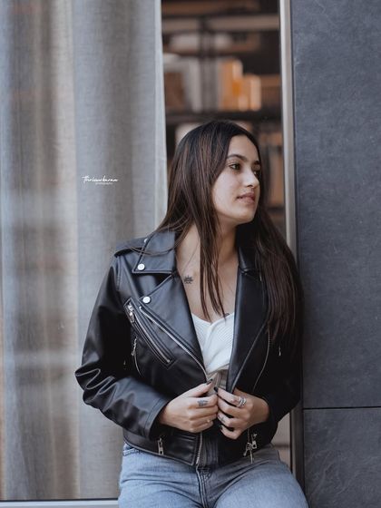 A classic street style look with a leather jacket against a modern architectural background. This shot shows how I use urban textures and lines to create a strong fashion statement.
