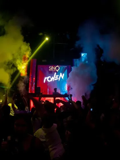 A mix of yellow and blue smoke fills the air at SinQ, Goa.