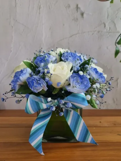 A lovely vase of blue and white flowers, a perfect fresh component to add to any Father's Day gift hamper.