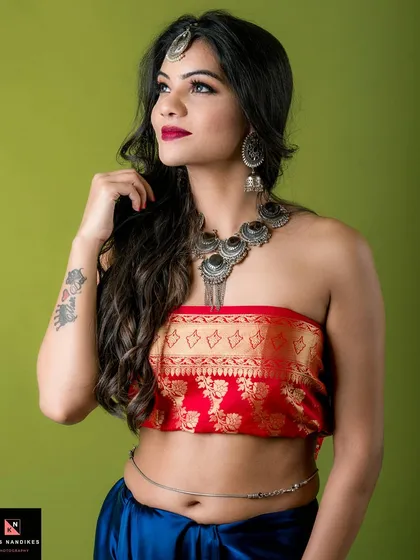 A celebration of color and heritage. This image blends a traditional silk top with striking silver jewelry against a vibrant background, capturing a divine and elegant look. It shows my ability to work with rich colors and ethnic styling.