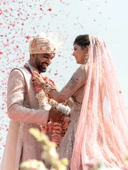 The perfect varmala moment, filled with smiles and a shower of flower petals. We ensure these key moments are captured beautifully against a stunning backdrop.