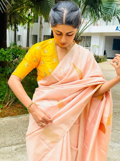 A simple and elegant look I put together. A peach-colored silk saree paired with a contrasting bright yellow blouse with delicate butti embroidery.