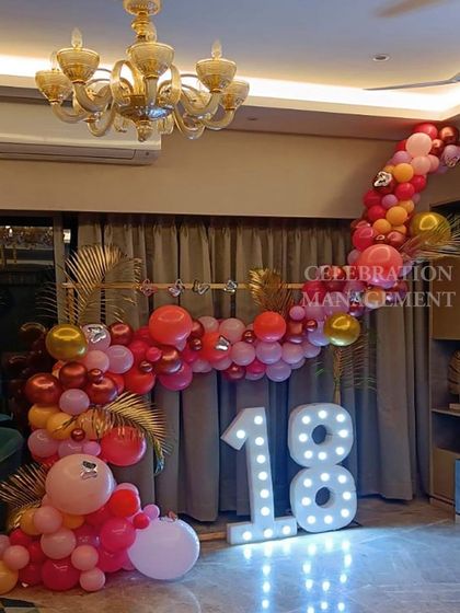 The golden palm leaves tucked into the balloon garland add a touch of glamour and tie into the tropical theme.