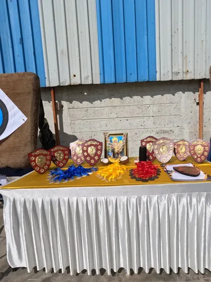 A display of the awards at one of our internal competitions, set against the backdrop of the archery targets. These events are crucial for tournament preparation.