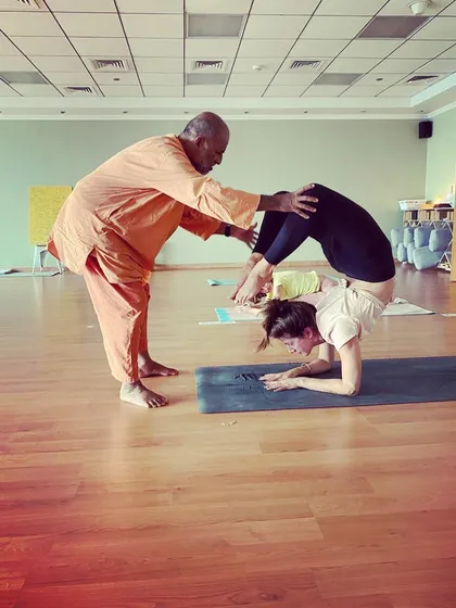 Personal guidance is the cornerstone of my teaching. Here, I assist a student in deepening their Vrischikasana (Scorpion Pose), ensuring safe alignment while helping them explore their physical and mental potential.