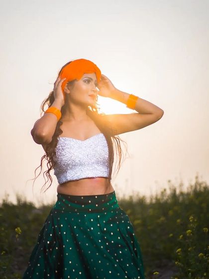 A sun-kissed shot from the Republic Day series, highlighting the model's profile and the vibrant orange turban against the golden hour light.