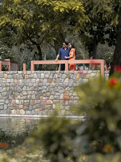 This is a classic outdoor pre-wedding portrait taken at a park in Delhi. I use natural light and scenic elements like this stone bridge to create beautiful, relaxed images for couples.