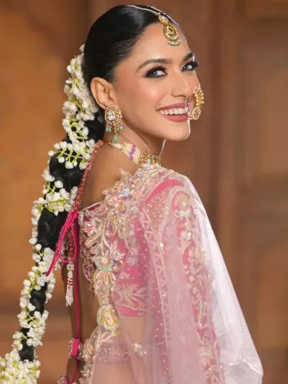 This over-the-shoulder shot captures the bride's joyful expression and the beautiful floral braid. It shows how a traditional hairstyle can feel fresh and modern in a campaign setting.