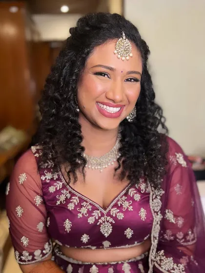 A happy and confident bride on her engagement day. The makeup is glamorous and modern, with a focus on her beautiful smile.