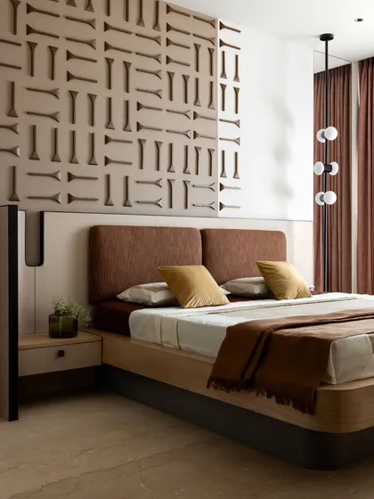 This bedroom design embodies quiet luxury, blending earthy tones, rich textures, and minimalist forms. The custom wall panel and curated furnishings create a harmonious and understatedly elegant atmosphere.