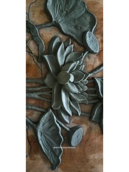Another angle of the raw clay sculpture, showing the intricate layering of the lotus flowers and pads. This careful arrangement creates a natural and balanced composition.