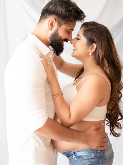 An intimate close-up that beautifully captures the love and excitement of expecting a child. The soft, high-key lighting creates a bright and airy feel.