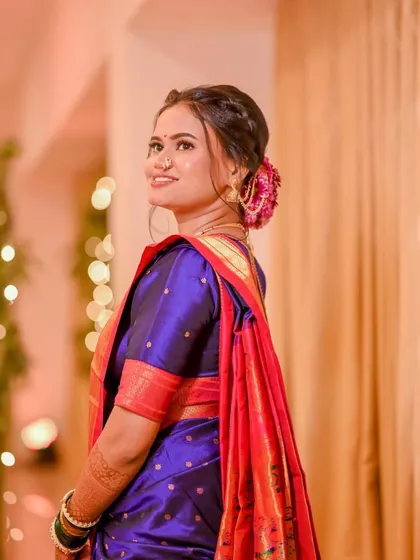A side profile showing the elegant hairstyle and flawless makeup. The look is timeless and perfect for a traditional wedding.