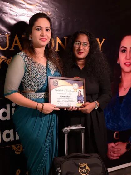 Another proud graduate receiving her certificate. Her journey to success in the beauty industry starts now.