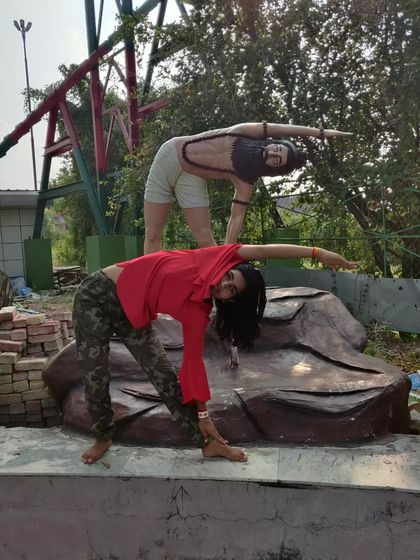 A playful Trikonasana (Triangle Pose) with my stone-faced yoga partner. Finding joy in the practice is key.